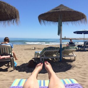 Person being successful working from home online while at the beach.