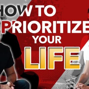 A man presenting a workshop on how to prioritize your life, standing next to a whiteboard with key points listed.