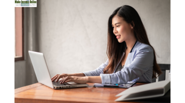 "Woman working from home on her computer, balancing work from home and family life."