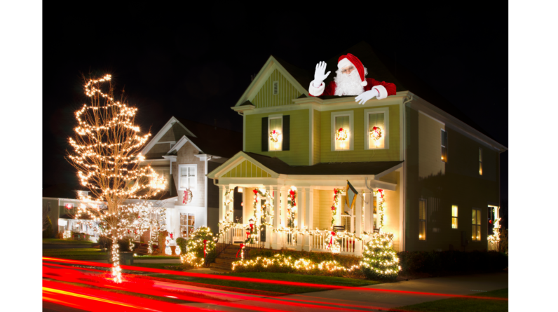 "A beautifully decorated house with Christmas lights and Santa Claus on the roof, creating a festive holiday scene."