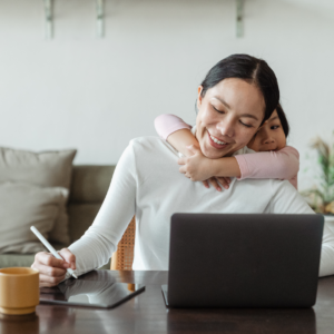 A woman working from home with her child, highlighting Amazon hiring work from home opportunities in 2024."