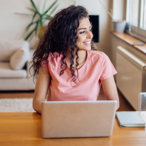 A woman working from home at her desk, highlighting Amazon careers from home opportunities in 2024."