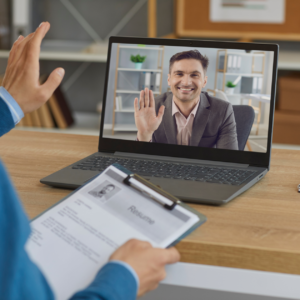 A man participating in a remote job interview from home on his computer, emphasizing work from home jobs in 2024."