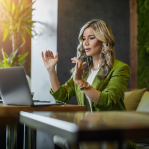 A woman working from home at her desk, representing work from home positions in 2024."