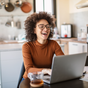 "A woman working from home on her computer, representing part-time remote jobs in 2024."