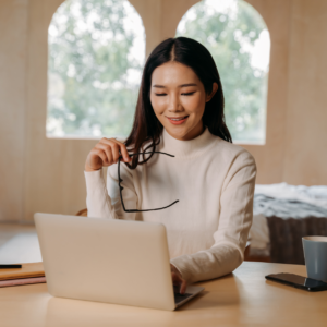 A woman working from home on her computer, representing part-time remote jobs in 2024."